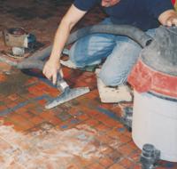 VACUUMING WATER FROM WET SAW USED IN CUTTING GROUT LINES AND REMOVAL OF WORN TILES